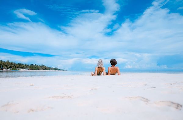 couple laying on tropical beach