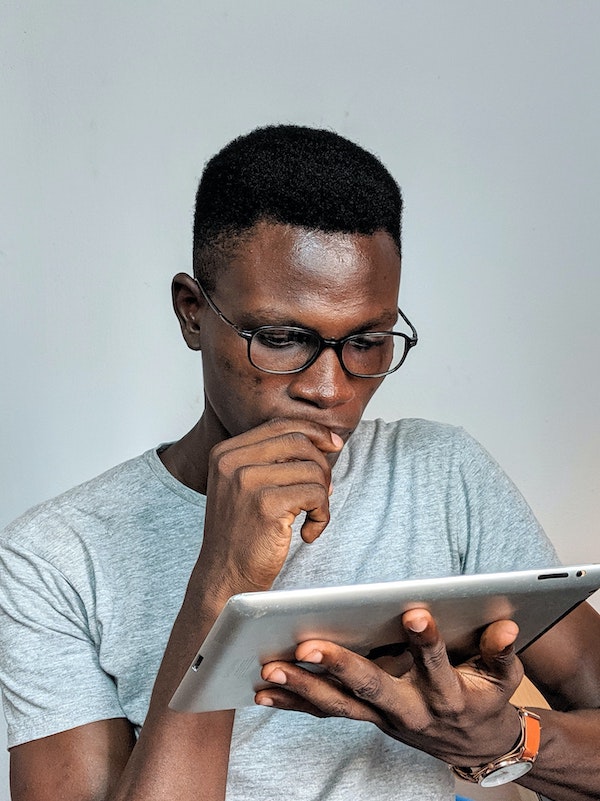man looking at tablet with worried expression